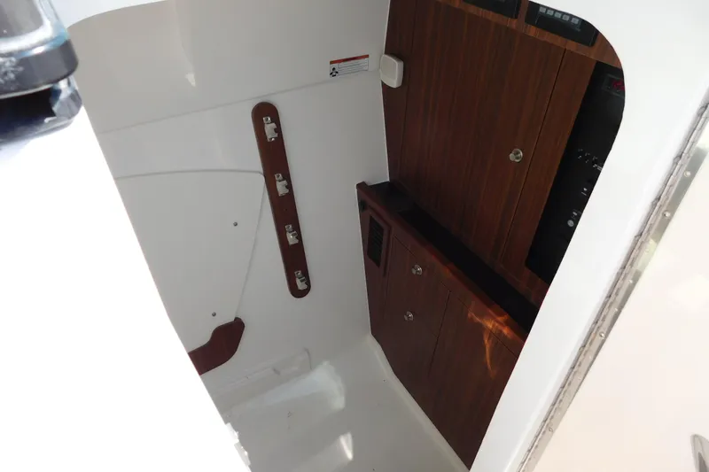  Yacht Photos Pics 2024 Pursuit DC 326 Dual Console interior with wood paneling and storage cabinets.