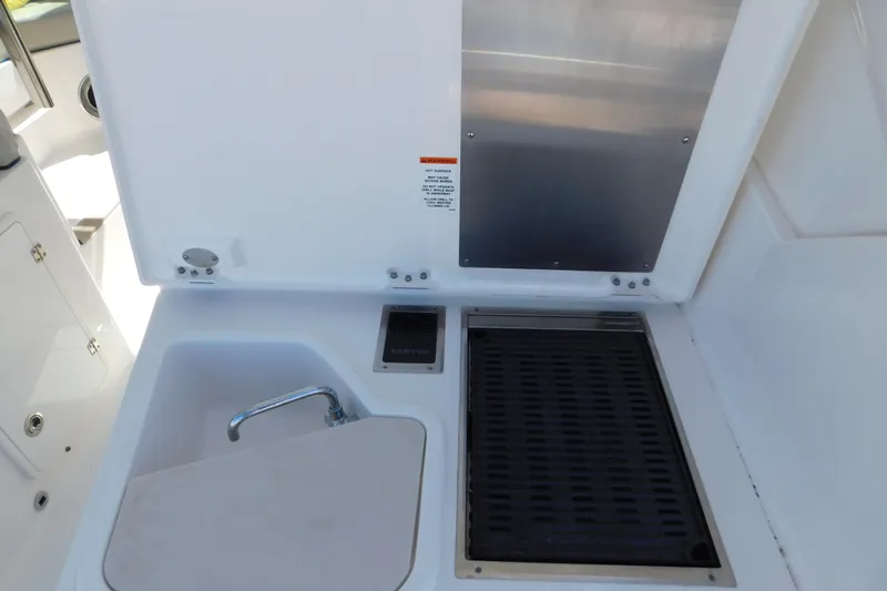 Yacht Photos Pics 2024 Pursuit DC 326 Dual Console boat interior with sink and grill station.