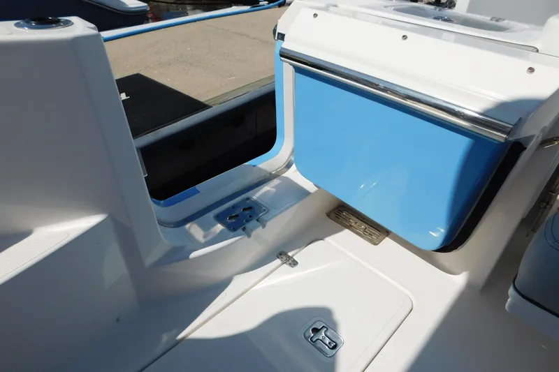  Yacht Photos Pics 2024 Pursuit DC 326 Dual Console boat interior with blue storage compartment.
