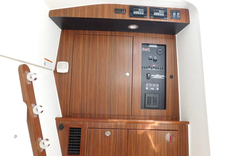  Yacht Photos Pics 2024 Pursuit DC 326 Dual Console interior with wood paneling and control panel.