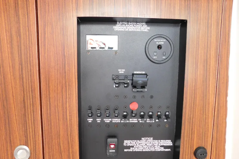  Yacht Photos Pics Electrical control panel on 2024 Pursuit DC 326 Dual Console boat, featuring switches and water alarm.