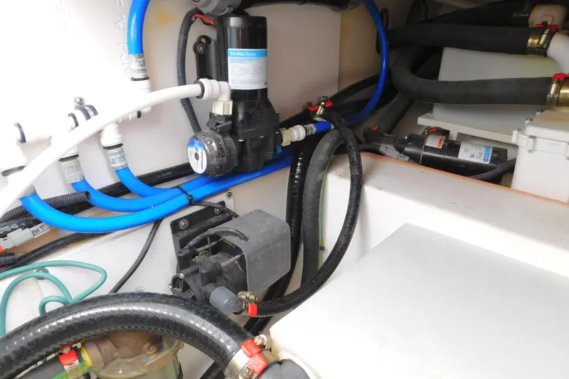  Yacht Photos Pics 2024 Pursuit DC 326 Dual Console boat engine compartment with hoses and pump system.