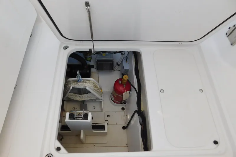  Yacht Photos Pics 2024 Pursuit DC 326 Dual Console storage compartment with fire extinguisher and equipment.