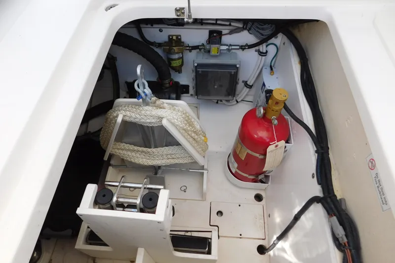  Yacht Photos Pics 2024 Pursuit DC 326 Dual Console storage compartment with fire extinguisher and equipment.