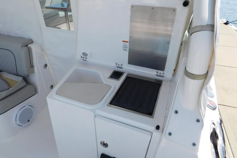  Yacht Photos Pics 2024 Pursuit DC 326 Dual Console boat interior with seating and utility area.