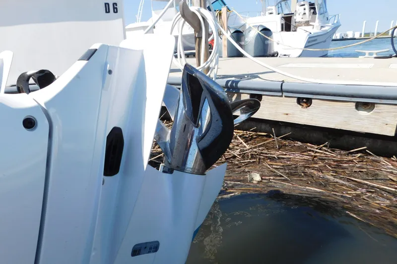  Yacht Photos Pics 2024 Pursuit DC 326 Dual Console boat docked with visible outboard motor.