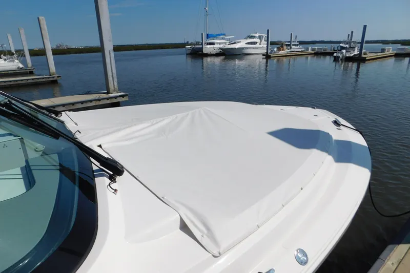  Yacht Photos Pics 2024 Pursuit DC 326 Dual Console boat docked at marina, covered bow area.
