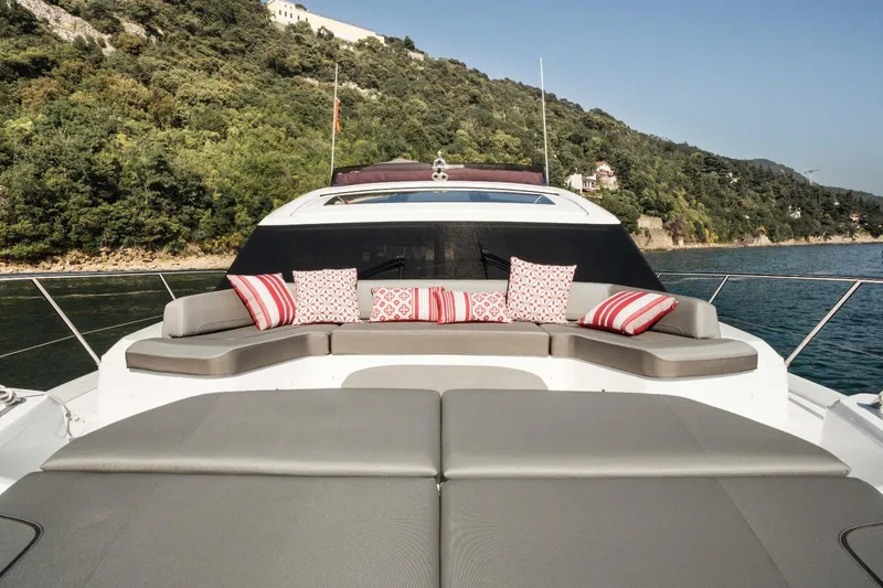  Yacht Photos Pics Luxurious 2018 Princess S65 yacht with stylish seating and scenic coastal backdrop.