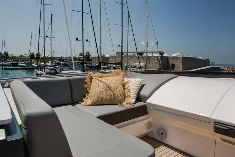  Yacht Photos Pics Luxurious 2018 Princess S65 yacht with elegant seating and cushions in a marina setting.