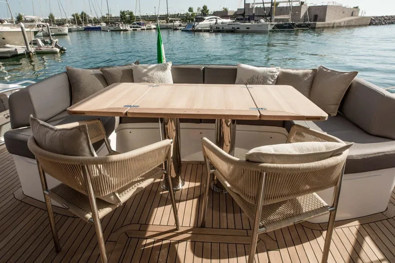  Yacht Photos Pics Luxury yacht Princess S65 2018 with elegant outdoor seating and scenic marina view.