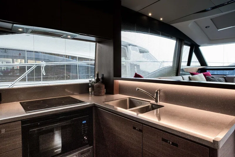  Yacht Photos Pics Luxurious kitchen interior of 2018 Princess S65 yacht with modern appliances and sleek design.