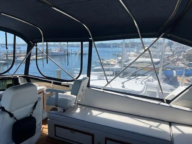 Ronda-vous Yacht Photos Pics Interior view of 1990 Jefferson 42 Viscount Sundeck yacht with marina backdrop.