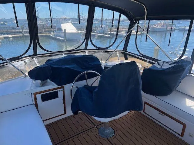 Ronda-vous Yacht Photos Pics 1990 Jefferson 42 Viscount Sundeck yacht interior with covered seating and marina view.