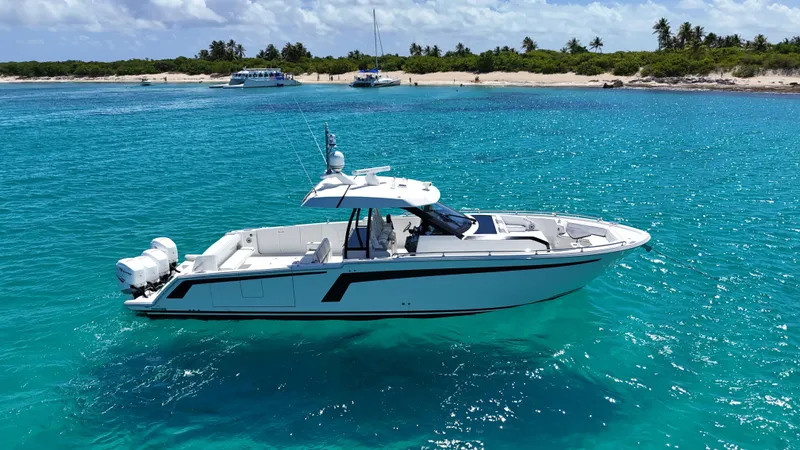  Yacht Photos Pics 2020 Ocean Alexander 45 Divergence Sport yacht on clear turquoise water near a tropical beach.