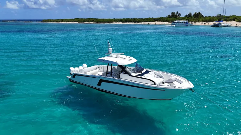  Yacht Photos Pics 2020 Ocean Alexander 45 Divergence Sport yacht on clear turquoise water near a sandy beach.