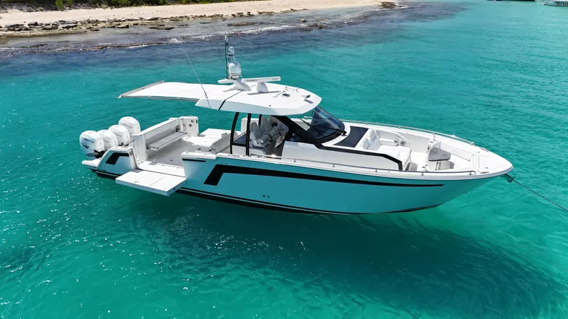  Yacht Photos Pics 2020 Ocean Alexander 45 Divergence Sport boat on turquoise water near sandy beach.