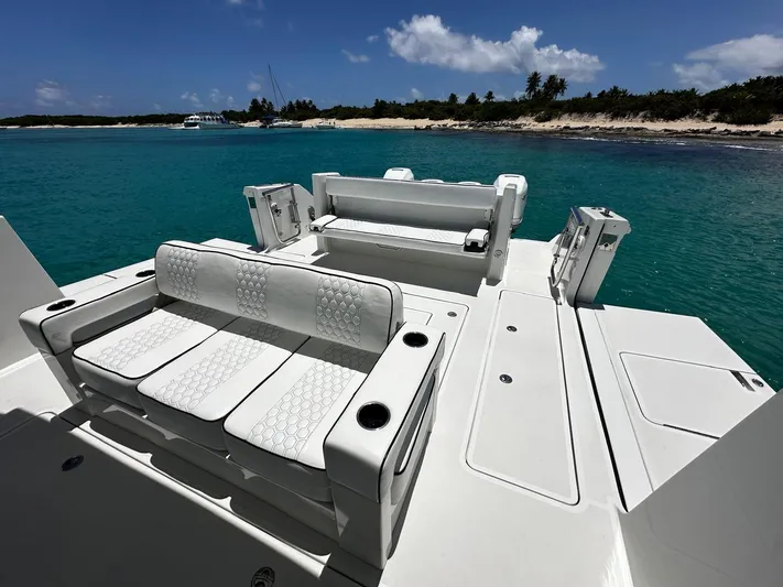  Yacht Photos Pics 2020 Ocean Alexander 45 Divergence Sport boat with luxurious seating, docked near a tropical shoreline.