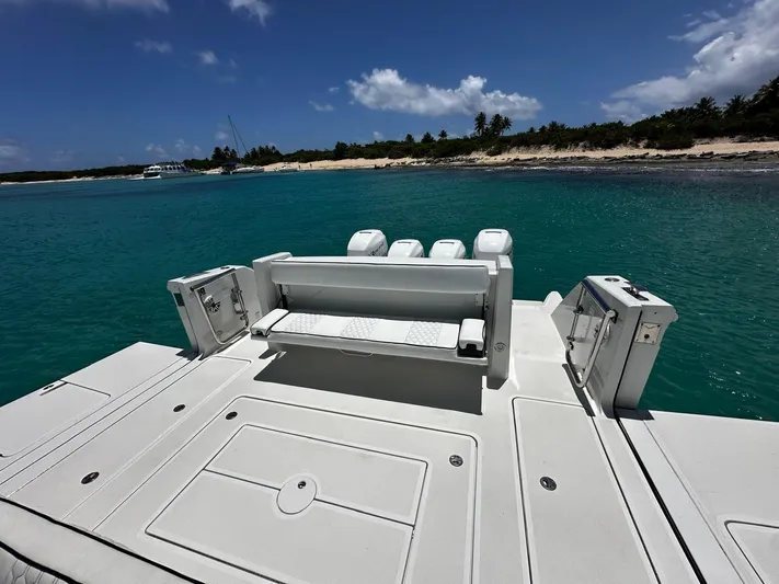  Yacht Photos Pics 2020 Ocean Alexander 45 Divergence Sport boat with spacious deck, anchored near tropical shoreline.