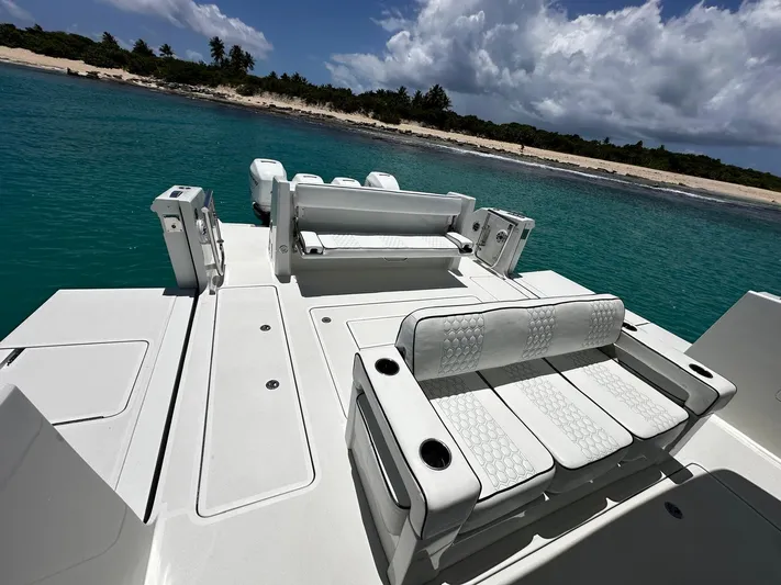  Yacht Photos Pics 2020 Ocean Alexander 45 Divergence Sport yacht with luxurious seating, anchored near a tropical beach.