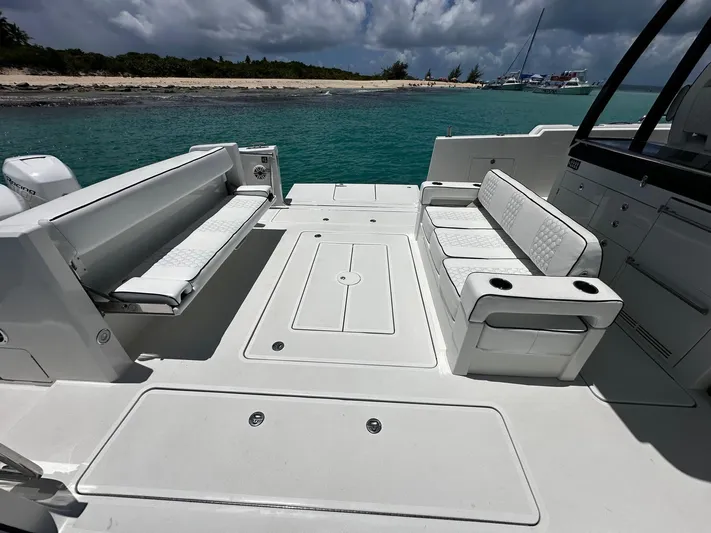  Yacht Photos Pics 2020 Ocean Alexander 45 Divergence Sport boat interior with seating, near a tropical shoreline.