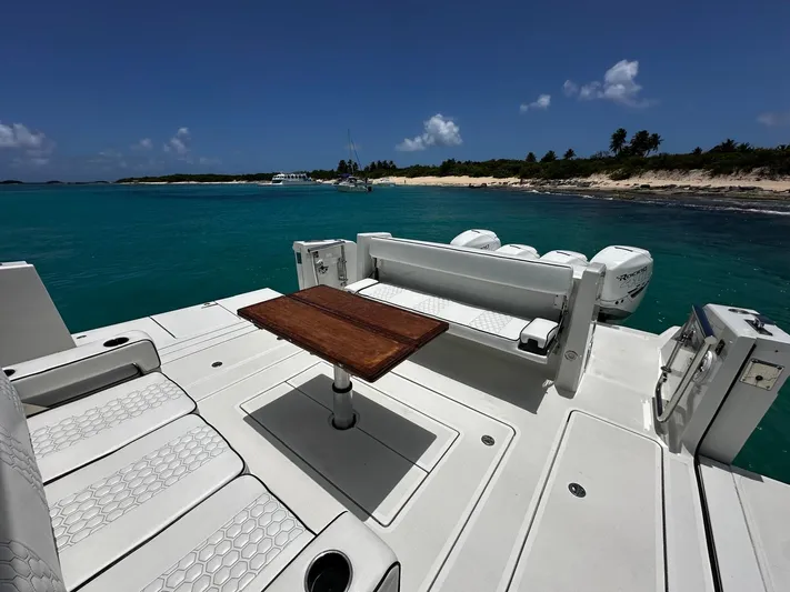  Yacht Photos Pics 2020 Ocean Alexander 45 Divergence Sport yacht with seating and table, near tropical shoreline.