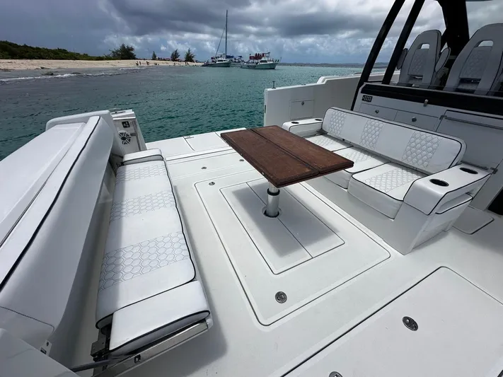  Yacht Photos Pics 2020 Ocean Alexander 45 Divergence Sport yacht with spacious seating and table, near a beach.