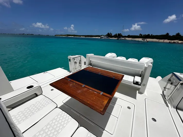  Yacht Photos Pics 2020 Ocean Alexander 45 Divergence Sport yacht with seating and table, overlooking turquoise waters.