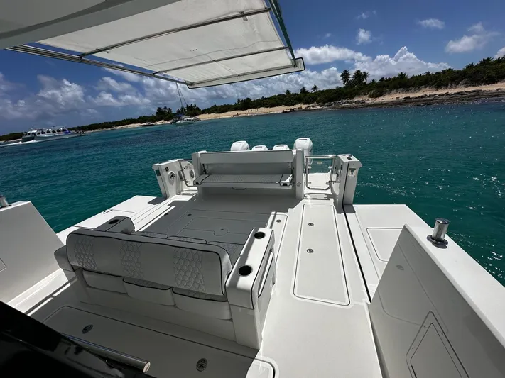  Yacht Photos Pics 2020 Ocean Alexander 45 Divergence Sport yacht with spacious deck, anchored near tropical shoreline.