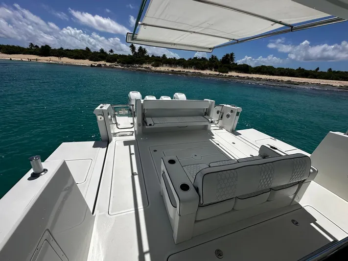  Yacht Photos Pics Ocean Alexander 45 Divergence Sport 2020 yacht with spacious deck, anchored near a tropical shoreline.