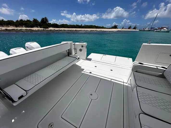  Yacht Photos Pics 2020 Ocean Alexander 45 Divergence Sport boat with spacious deck, near a scenic shoreline.