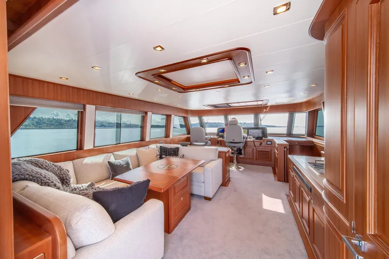 750 Skylounge Yacht Photos Pics Luxurious interior of 2022 Hampton Endurance 750 LRC yacht with plush seating and panoramic windows.