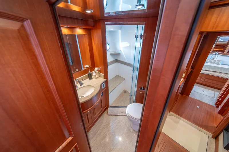 750 Skylounge Yacht Photos Pics Luxurious bathroom in 2022 Hampton Endurance 750 LRC yacht with wood accents and modern fixtures.