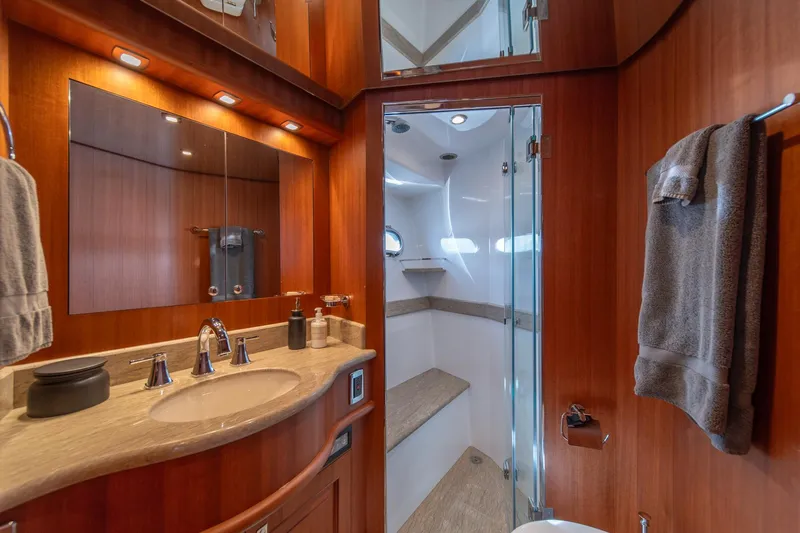 750 Skylounge Yacht Photos Pics Luxurious bathroom in 2022 Hampton Endurance 750 LRC yacht with wood accents and modern fixtures.