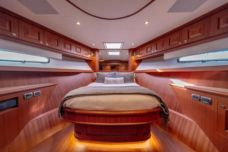 750 Skylounge Yacht Photos Pics Luxurious bedroom interior of 2022 Hampton Endurance 750 LRC yacht with wood paneling.