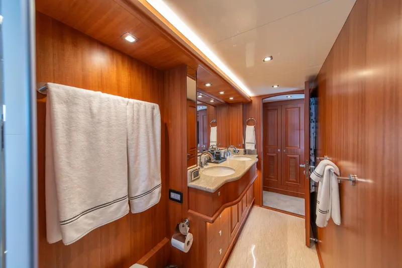 750 Skylounge Yacht Photos Pics Luxurious bathroom interior of 2022 Hampton Endurance 750 LRC yacht with wooden finishes.
