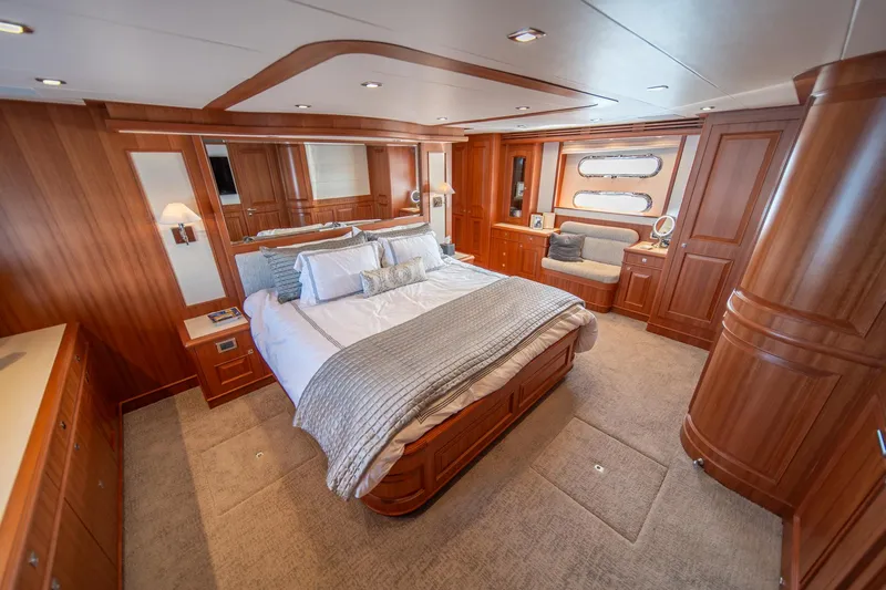 750 Skylounge Yacht Photos Pics Luxurious bedroom interior of 2022 Hampton Endurance 750 LRC yacht with elegant wood finishes.