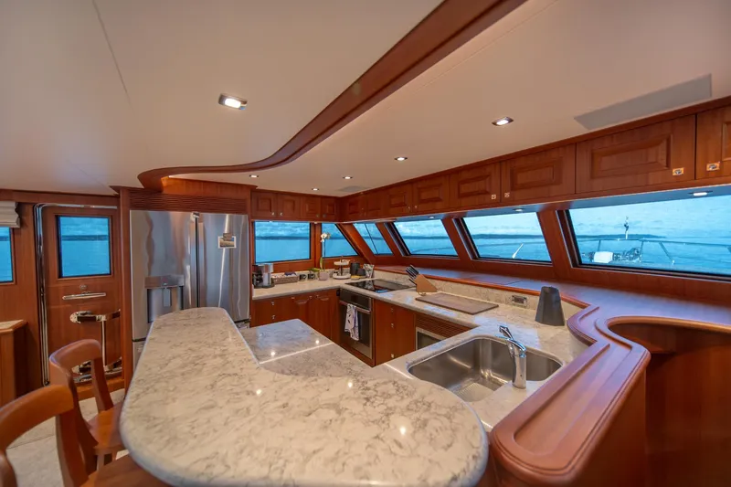 750 Skylounge Yacht Photos Pics Luxurious kitchen interior of 2022 Hampton Endurance 750 LRC yacht with ocean view.