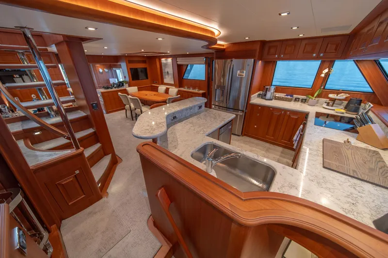750 Skylounge Yacht Photos Pics Luxurious interior of 2022 Hampton Endurance 750 LRC yacht with modern kitchen and dining area.