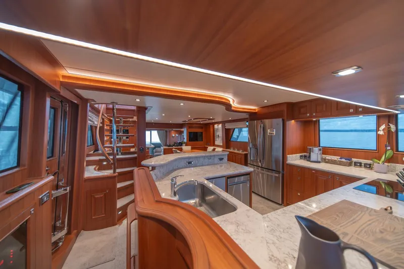 750 Skylounge Yacht Photos Pics Luxurious interior of 2022 Hampton Endurance 750 LRC yacht with modern kitchen and wooden finishes.
