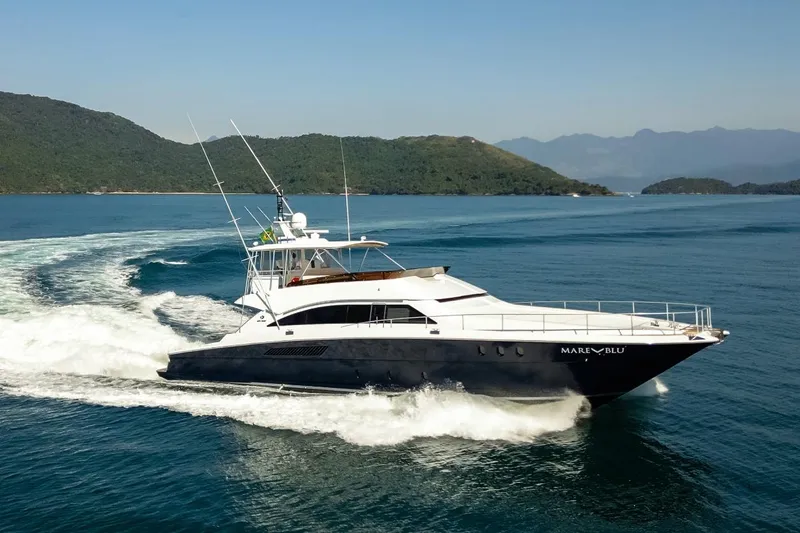 Mare Blu Yacht Photos Pics 2008 Pro Boat Yachts Power Cat 80 cruising on blue ocean near lush islands.