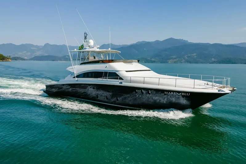 Mare Blu Yacht Photos Pics 2008 Pro Boat Yachts Power Cat 80 cruising on serene waters with mountainous backdrop.