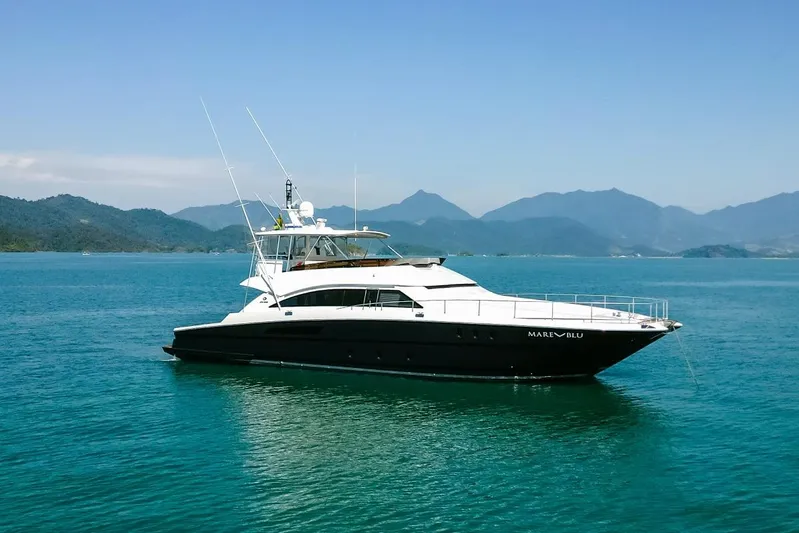 Mare Blu Yacht Photos Pics 2008 Pro Boat Yachts Power Cat 80 on serene blue waters with mountainous backdrop.