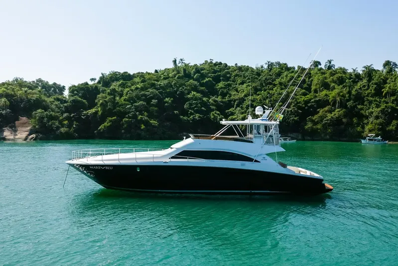 Mare Blu Yacht Photos Pics 2008 Pro Boat Yachts Power Cat 80 on turquoise water near lush green island.