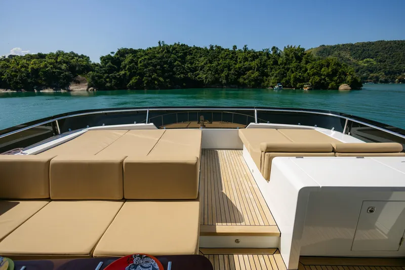 Mare Blu Yacht Photos Pics Luxurious deck of 2008 Pro Boat Yachts Power Cat 80, overlooking serene waters and lush greenery.