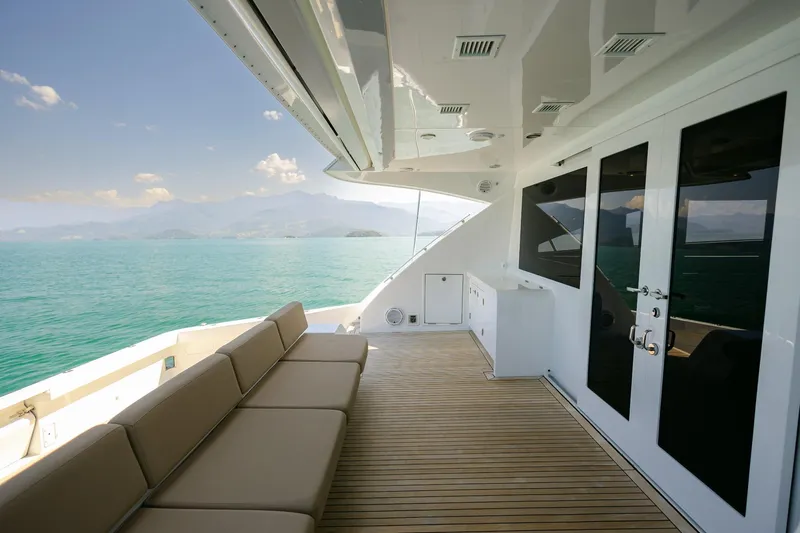 Mare Blu Yacht Photos Pics Luxurious 2008 Pro Boat Yachts Power Cat 80 deck with seating, overlooking serene ocean view.