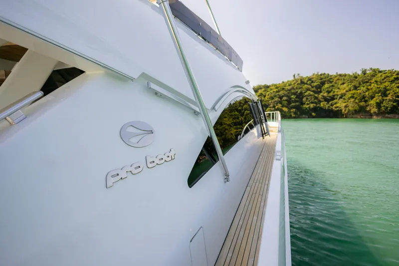 Mare Blu Yacht Photos Pics Pro Boat Yachts Power Cat 80, 2008 model, cruising near lush green island.