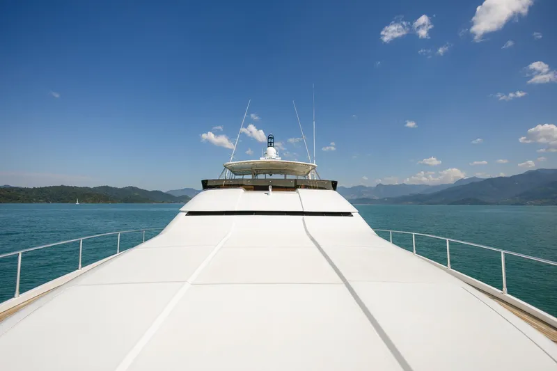 Mare Blu Yacht Photos Pics 2008 Pro Boat Yachts Power Cat 80 cruising on a serene lake under a clear blue sky.