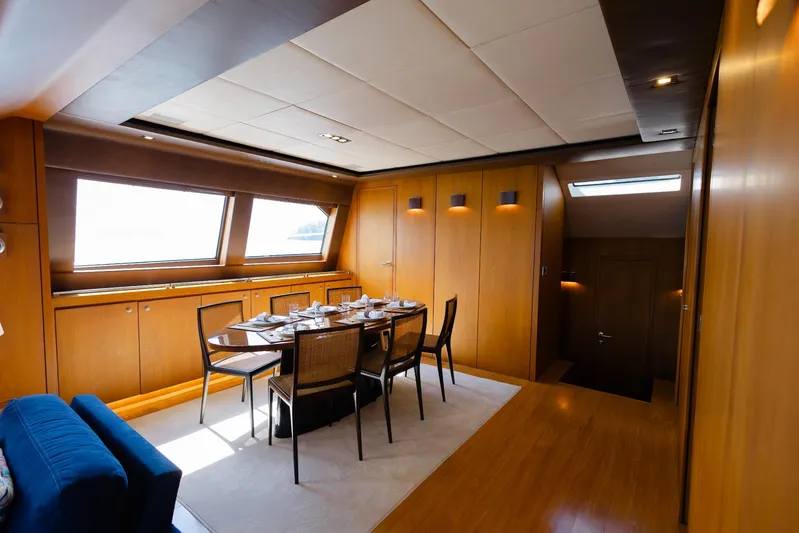 Mare Blu Yacht Photos Pics Luxurious dining area inside 2008 Pro Boat Yachts Power Cat 80, featuring elegant wood paneling.