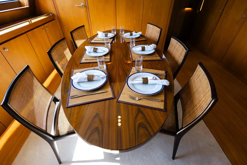 Mare Blu Yacht Photos Pics Luxurious dining setup on 2008 Pro Boat Yachts Power Cat 80, featuring elegant tableware and wooden decor.