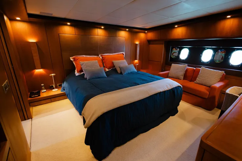 Mare Blu Yacht Photos Pics Luxurious bedroom in 2008 Pro Boat Yachts Power Cat 80, featuring elegant decor and cozy seating.